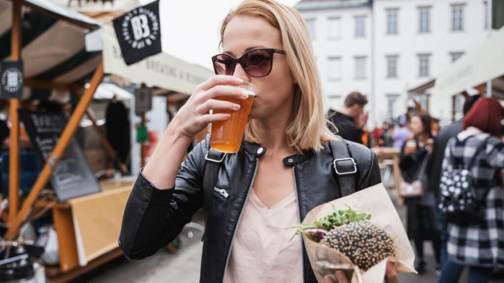 Blonde woman eating street food in Slovenia.