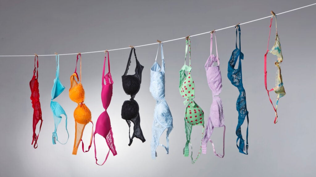 Colorful bras hanging on clothesline.