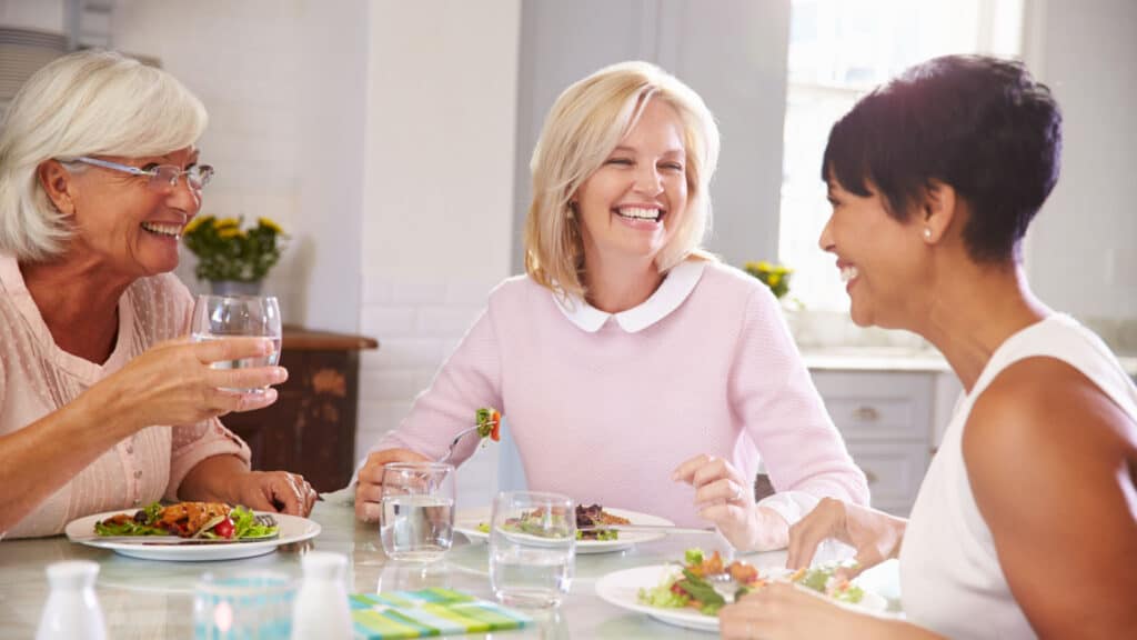 3 mature women eating.