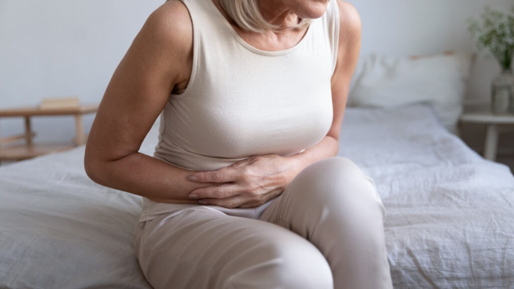 Older woman in stomach pain. 