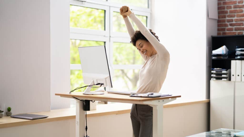 Woman stretching at standing desk.