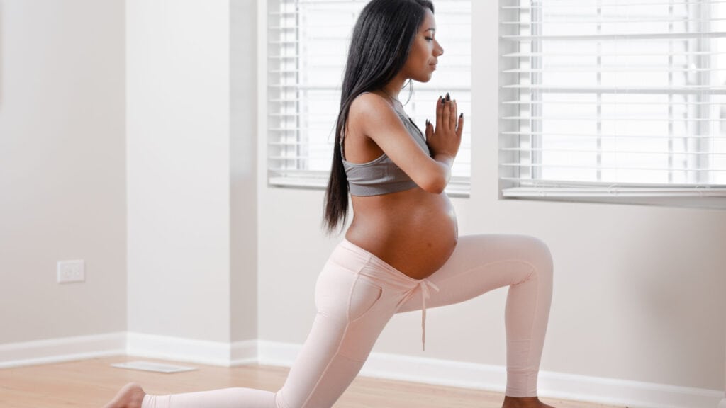 pregnant woman holding yoga pose. 