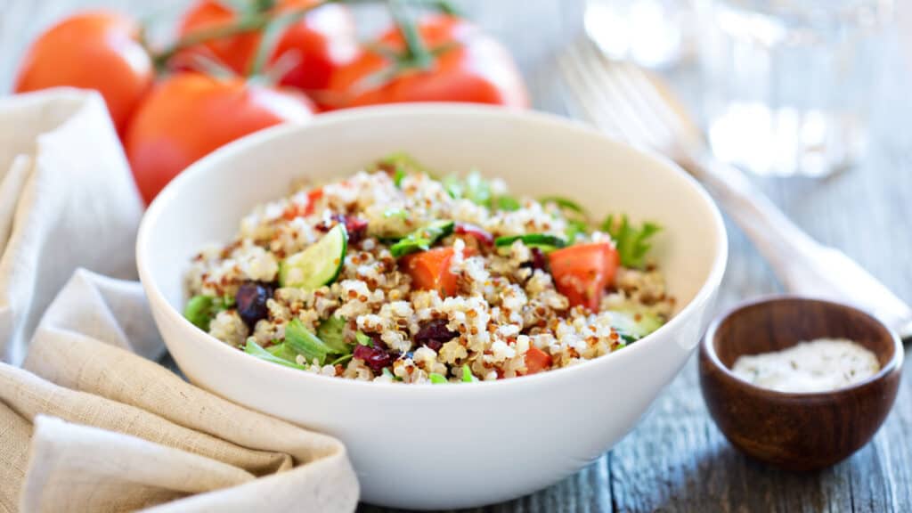 quinoa vegetable salad in white bowl. 