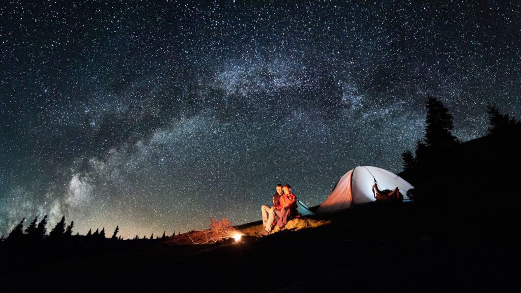 Couple camping at night.