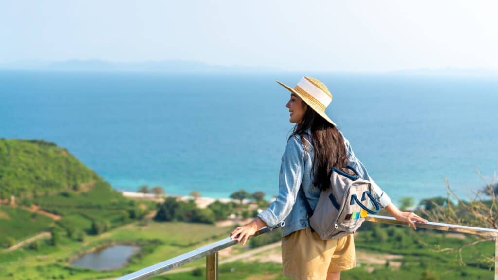 Happy woman traveling. Image credit CandyRetriever via Shutterstock.