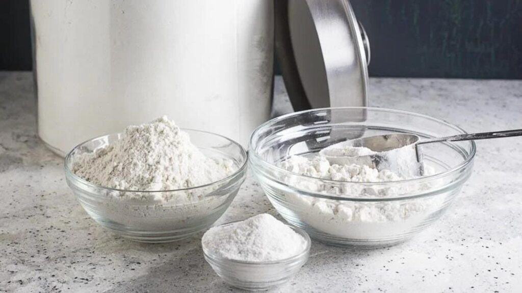 Making-DIY-gluten-free-flour-belnd-assortment-of-flours-in-glass-bowls-with-a-measuring-cup.