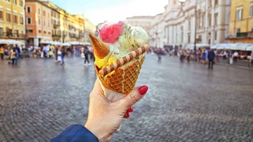 Manicured hand holding ice cream in Italy.