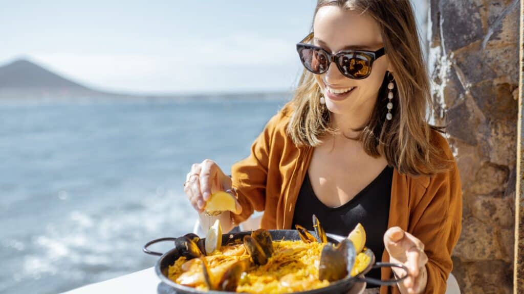 Woman eating paella. 