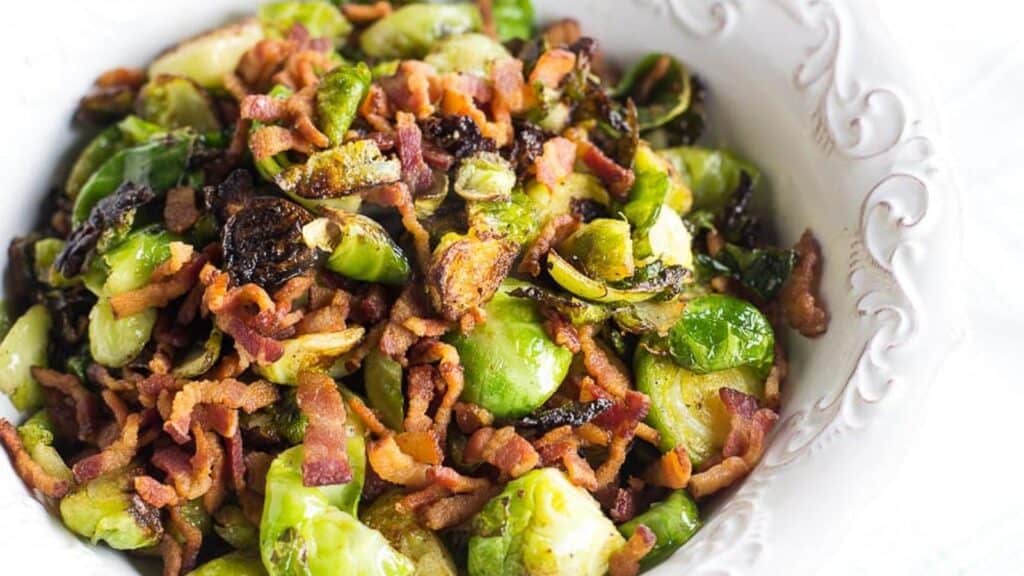 Brussels-sprouts-and-bacon-in-white-dish-with-raised-decorative-edge.