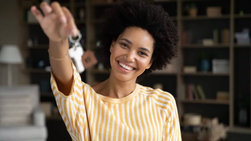 woman holding keys to home.