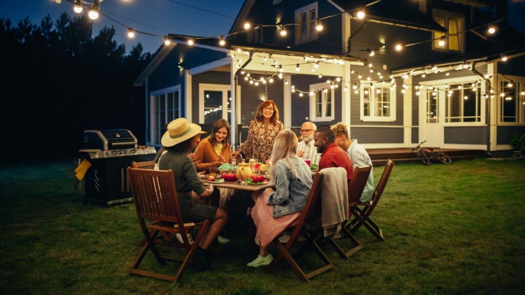 Group eating outdoors at night. 