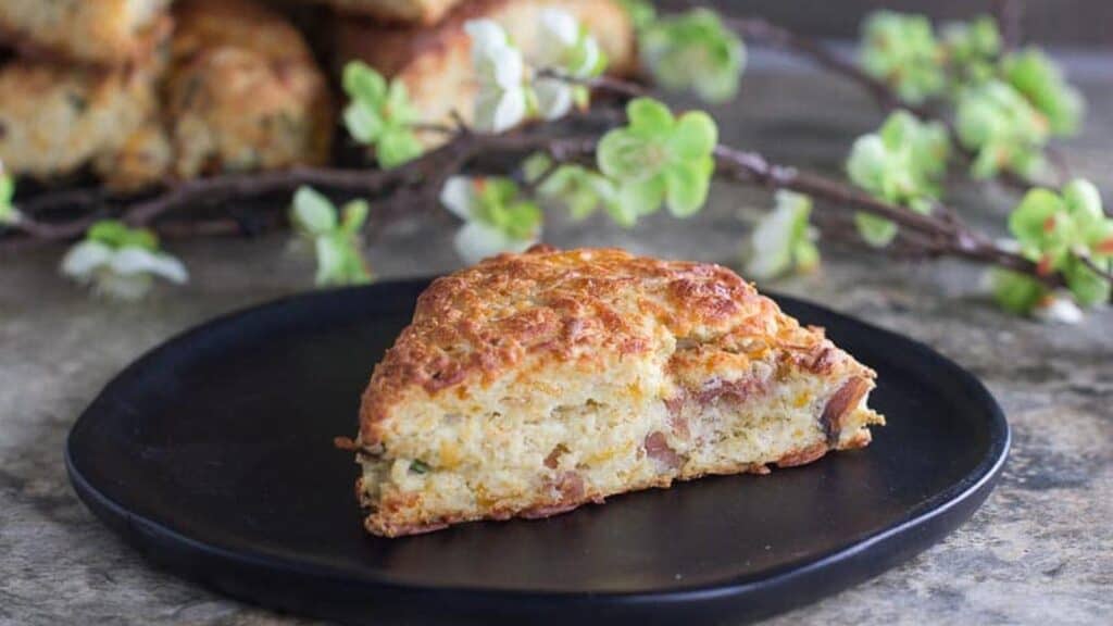 horizontal-image-of-low-FODMAP-Ham-Cheese-Scones-on-black-wooden-plate.
