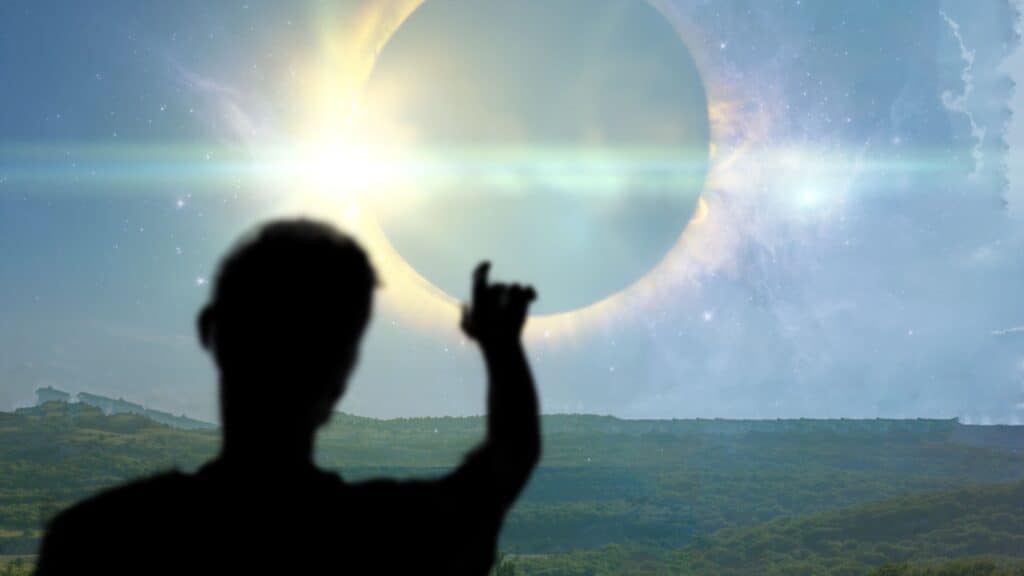 man pointing at solar eclipse. 