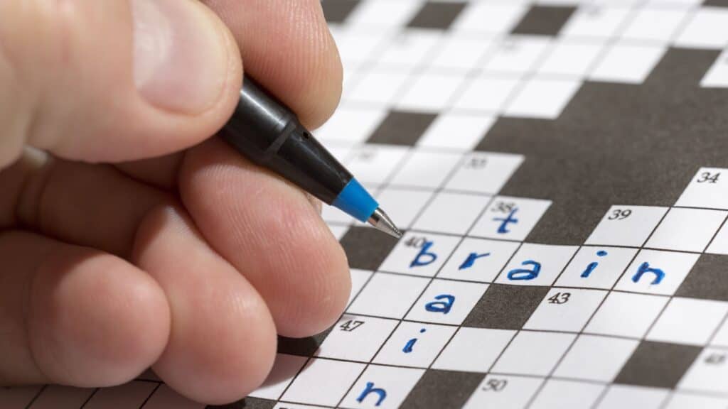 Doing crossword puzzle. 