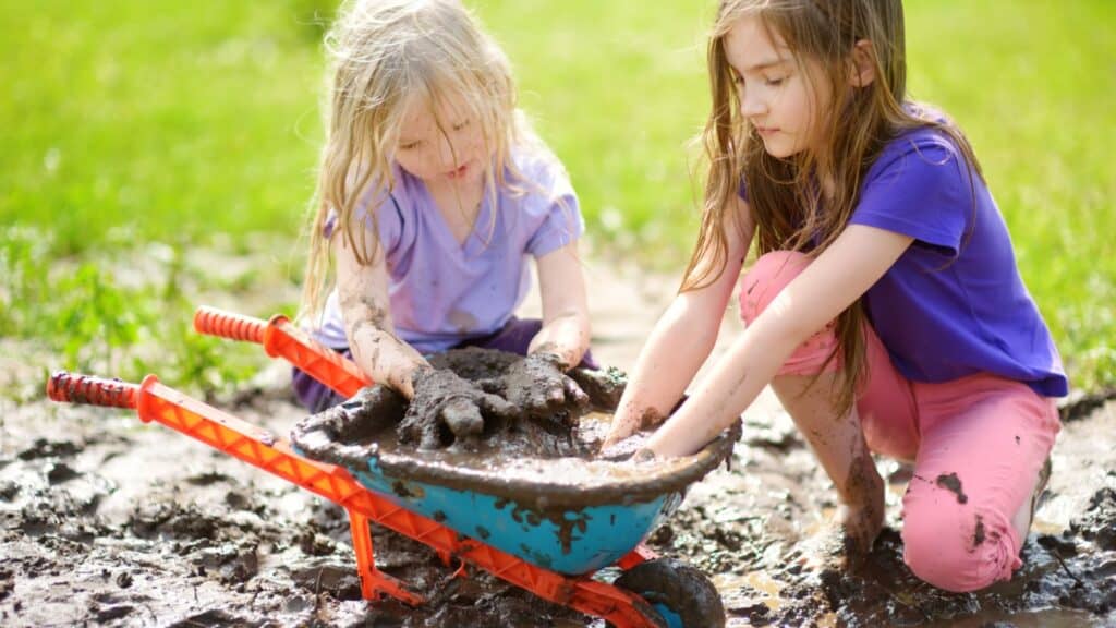 Girls playing in mud. 