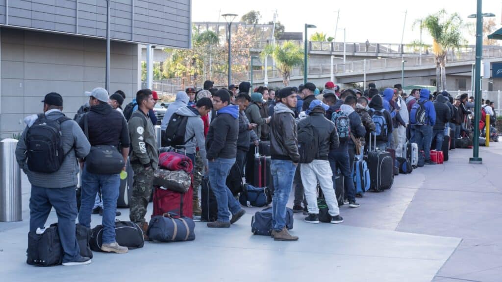 migrant workers lined up for work