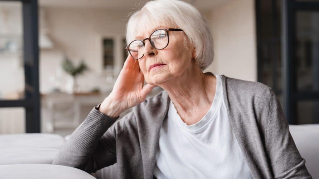Sad, tired lonely senior woman. Image credit Inside Creative House via Shutterstock..