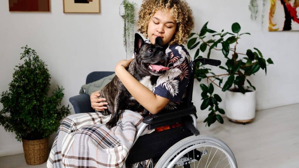 Woman in wheelchair with dog.