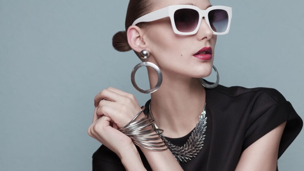 Woman wearing jewelry and sunglasses. 