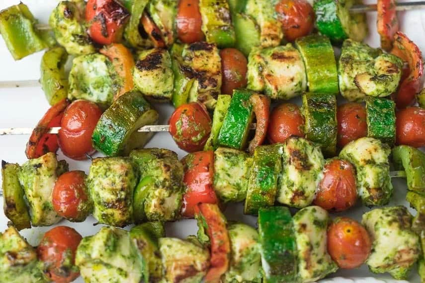 closeup-of-grilled-chicken-and-vegetable-kebobs-on-a-white-platter.