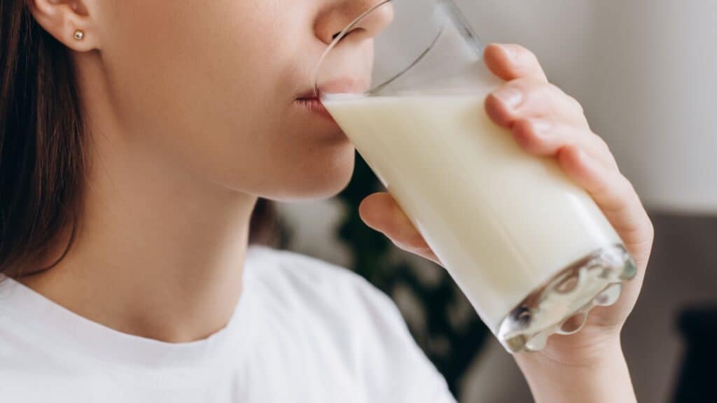 woman drinking milk.Image credit Yurii_Yarema via Shutterstock.
