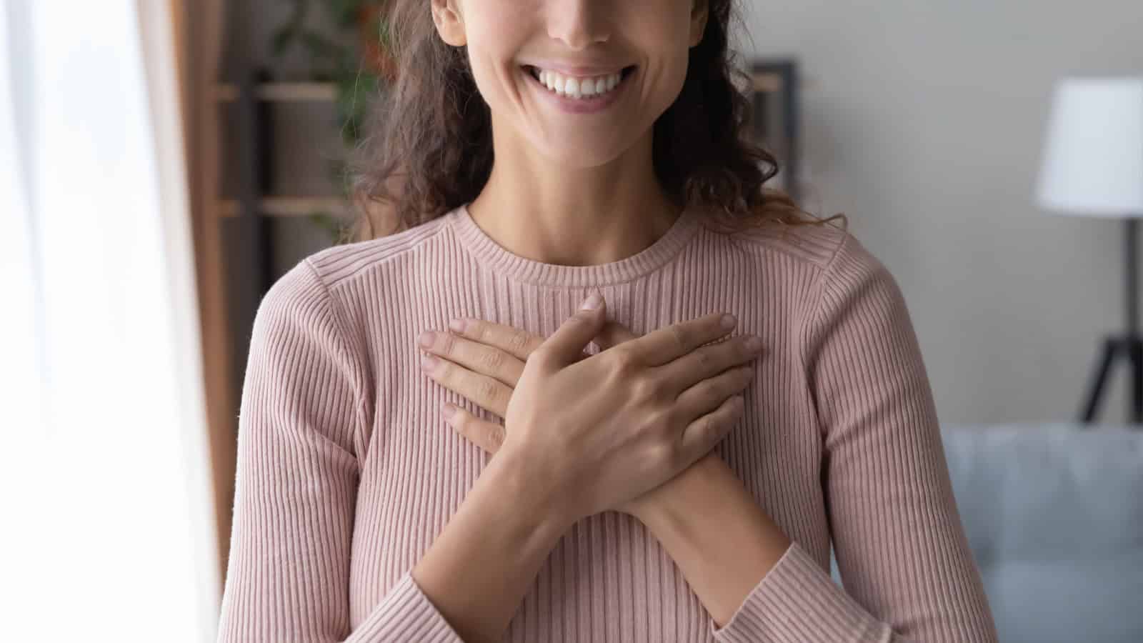 woman with hand over heart. 