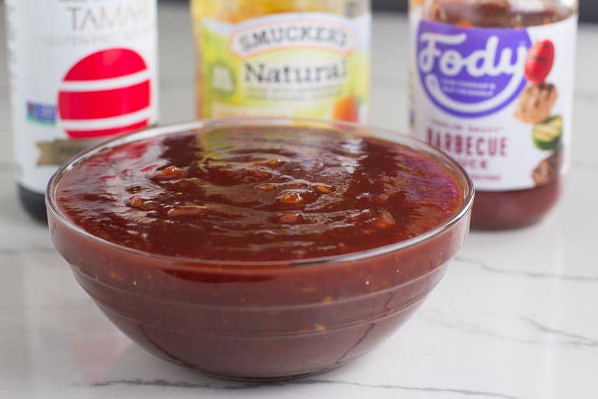 Orange-marmalade-BBQ-Sauce-in-glass-bowl-with-ingredients-in-background.