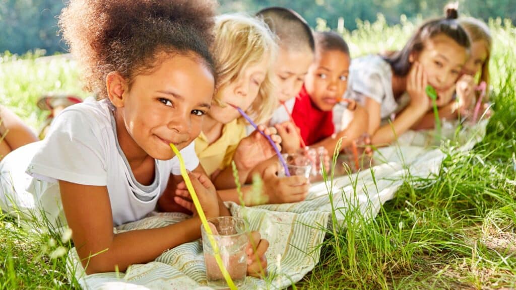 Kids drinking water from straws.