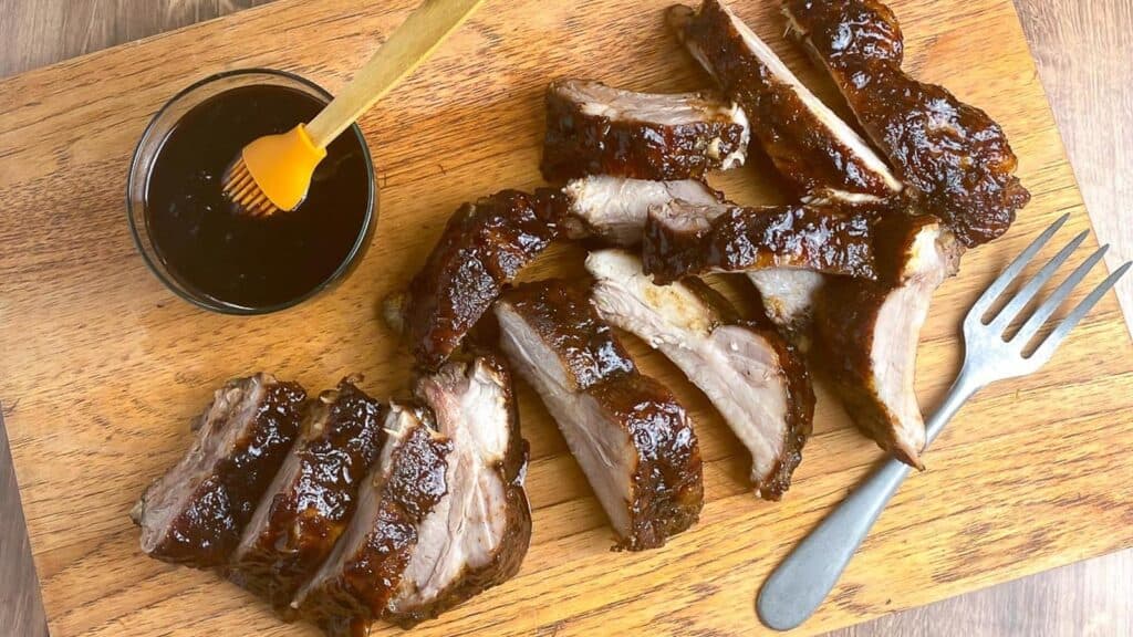 5-Spice-Ribs-with-Plum-sauce-on-board-and-with-bowl-of-sauce.