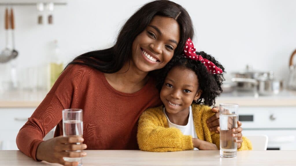 Mom and daughter drinking water.