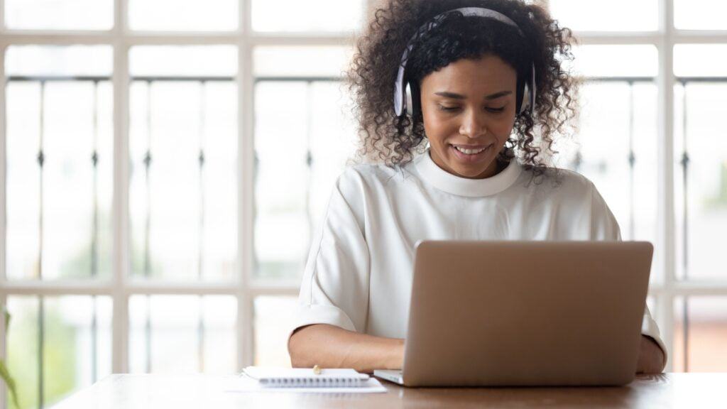 Woman working on laptop.