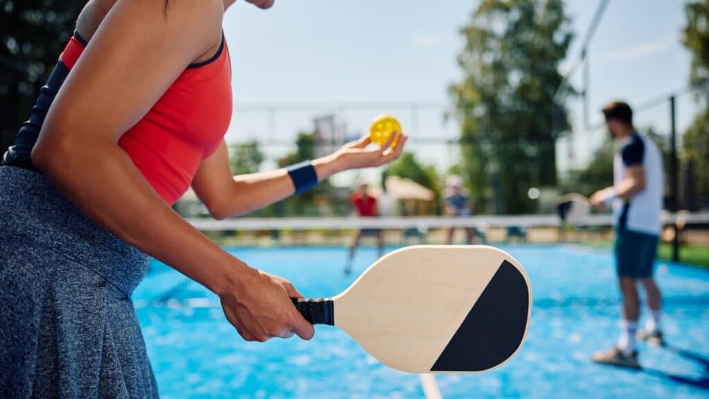 woman playing pickleball.