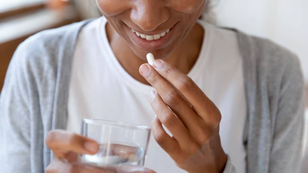 woman taking pill.
