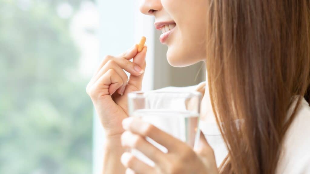 woman taking pills. 