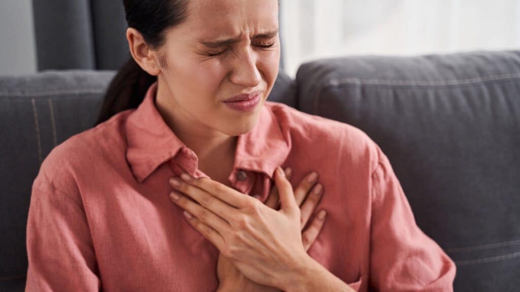 women holding chest. Heart attack. 