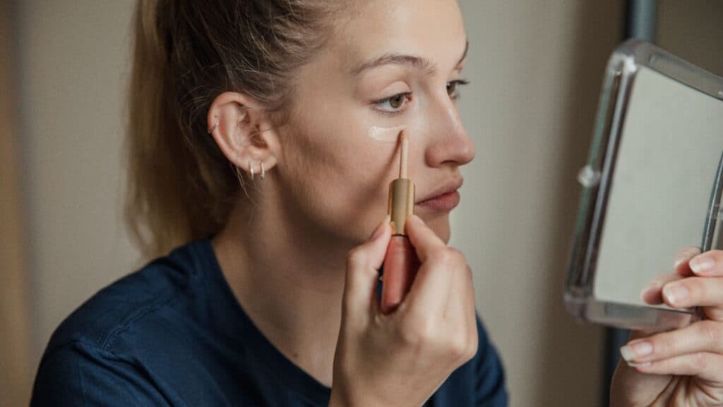 Applying concealer. 