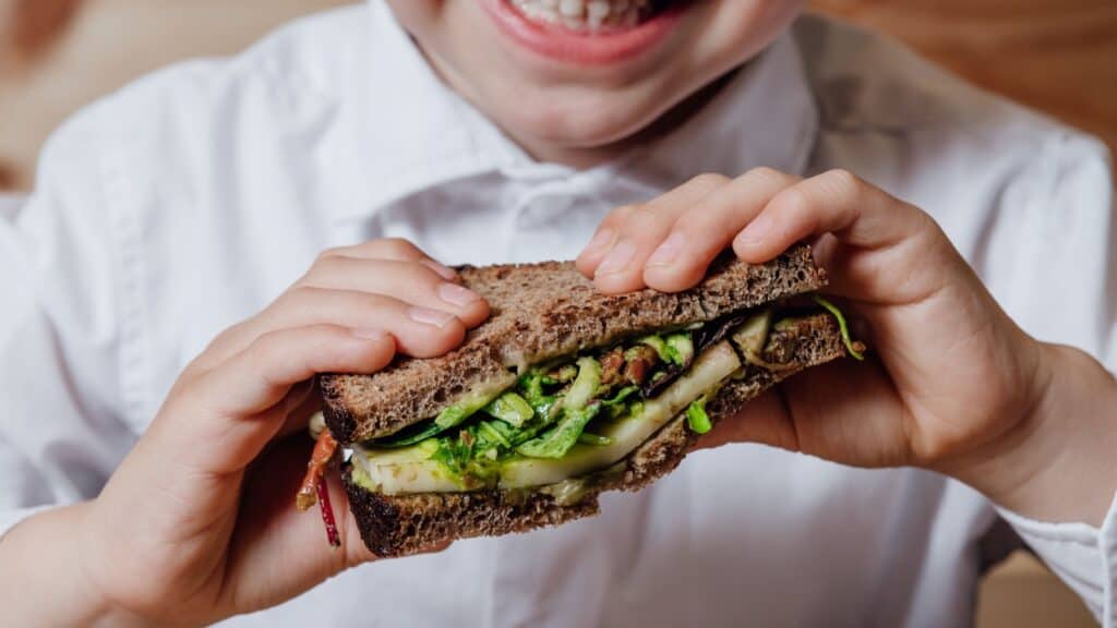 Child with whole grain salad. 