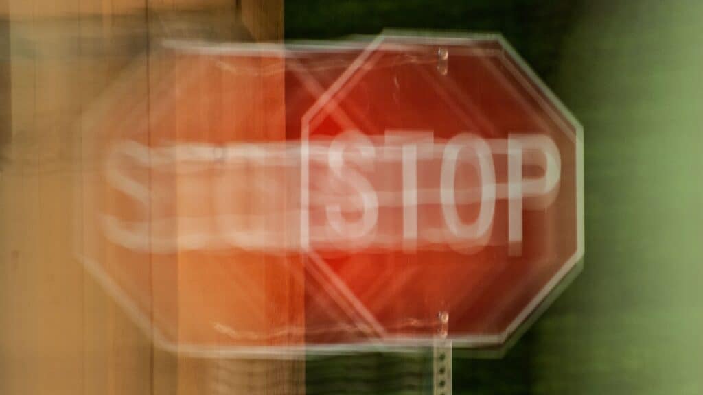 Impaired driving stop sign. Blurry. 