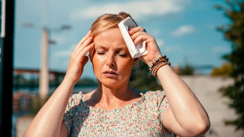 woman sweating in heat and hot sun