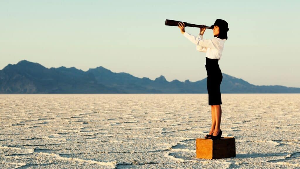 a woman looking through a telescope - vision