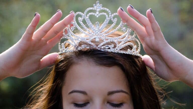 Crown being placed on woman's head.