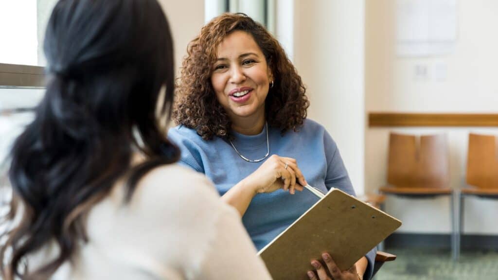 two women talking - office 