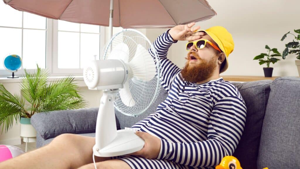 man with fan, humor, hot, heat