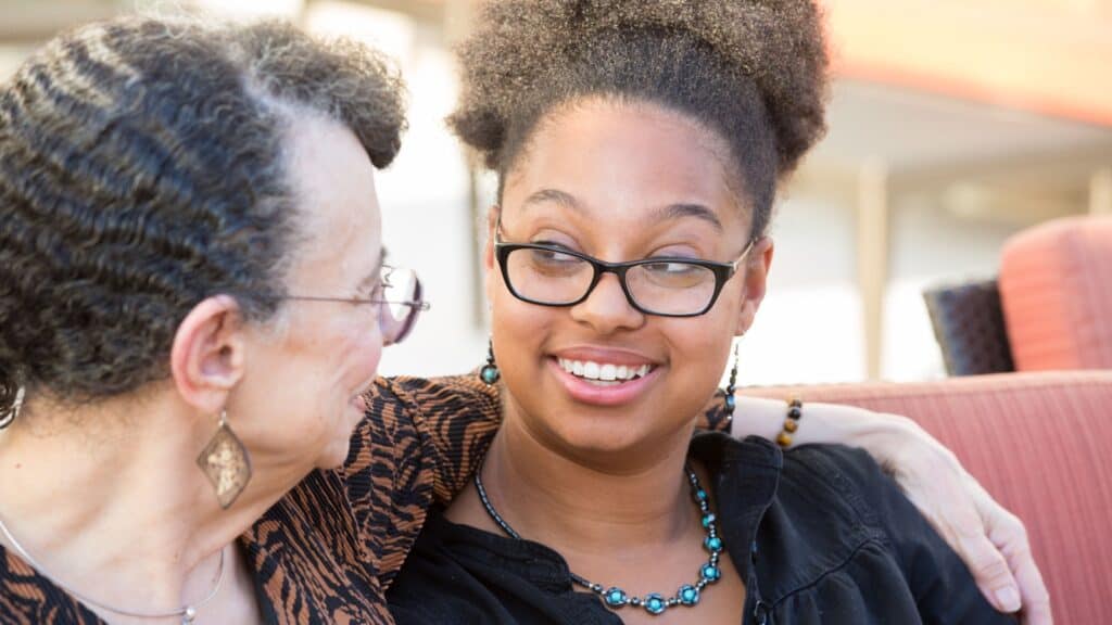 Senior talking to younger woman. 