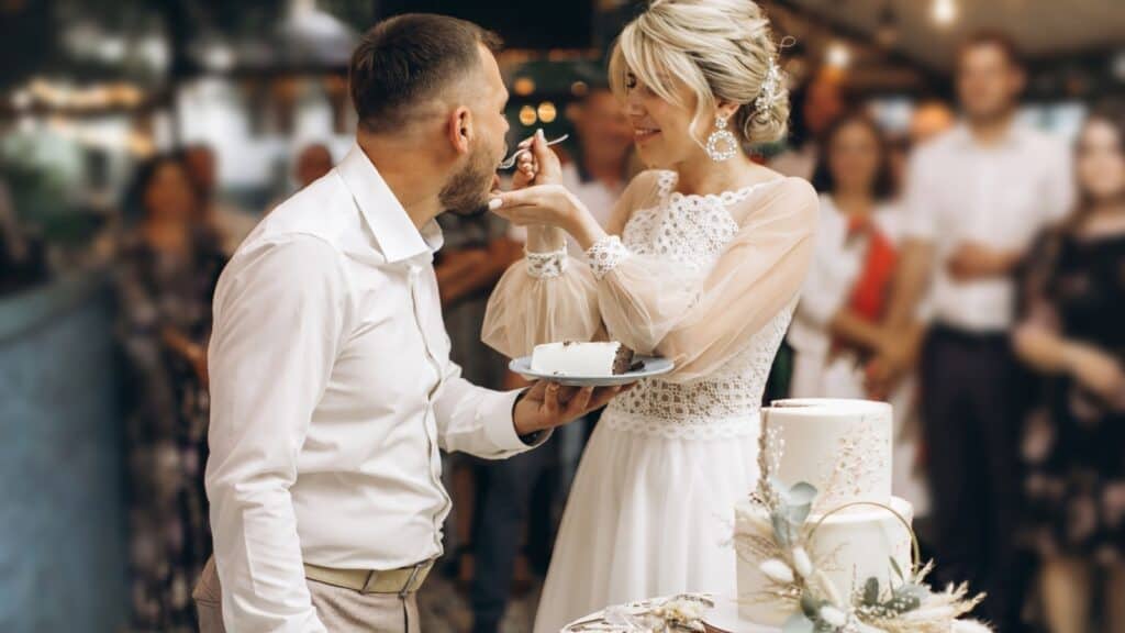 Sharing wedding cake.