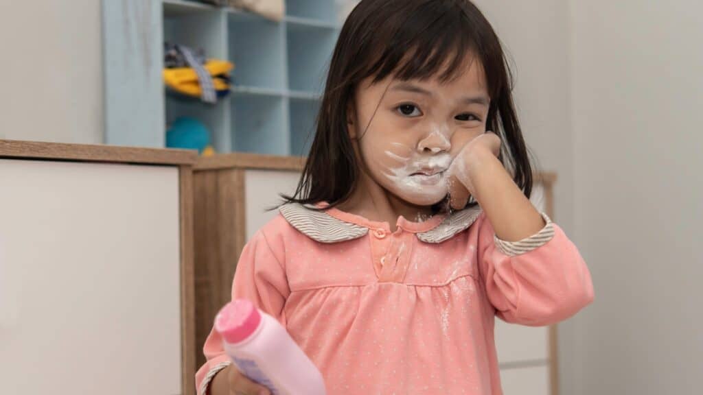 Too much powder on little girl's face. 