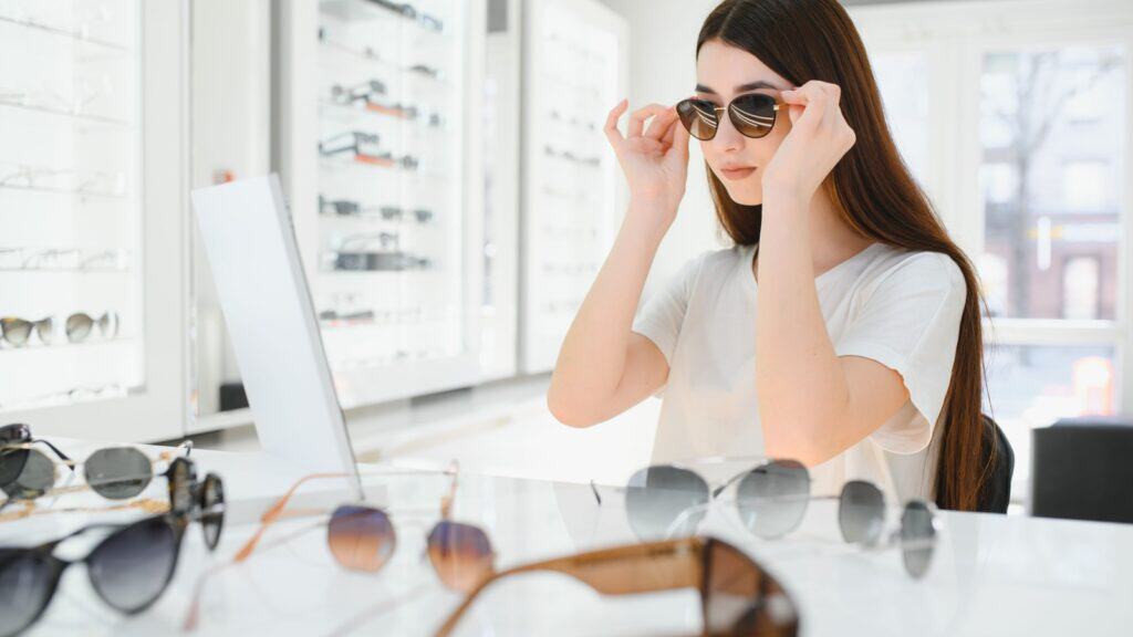 Trying on sunglasses.