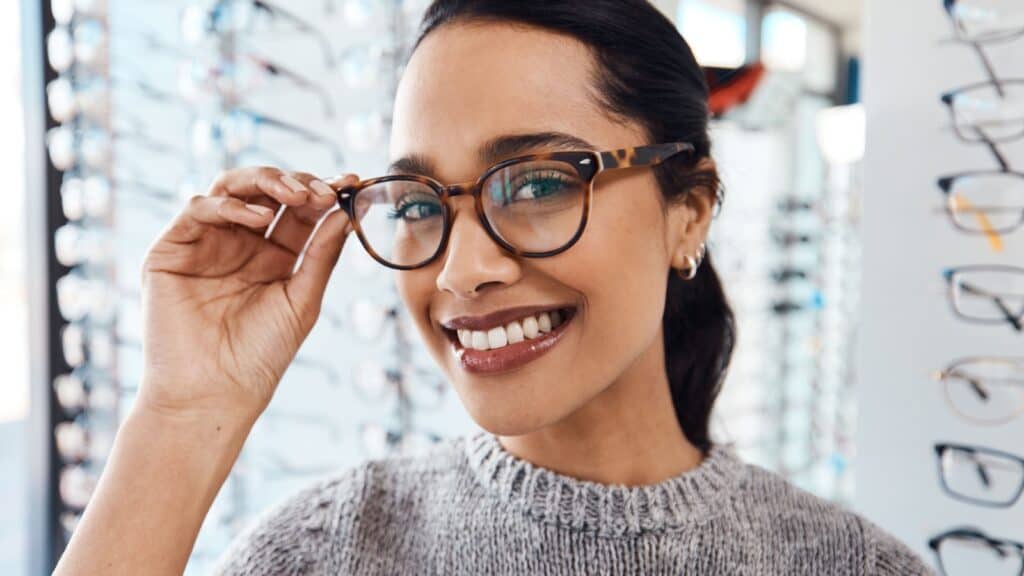 Woman trying on glasses.