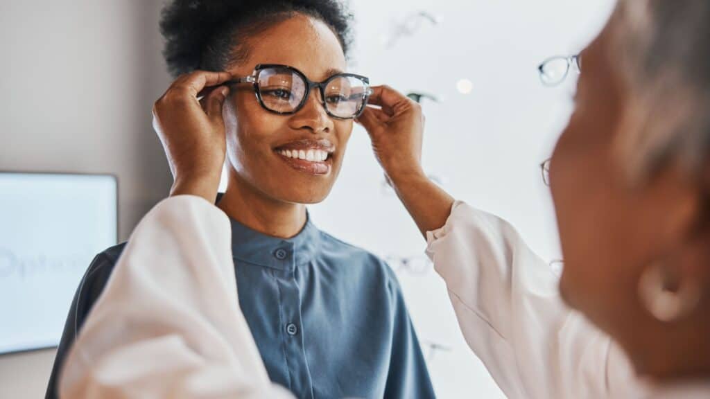 Woman trying on glasses.