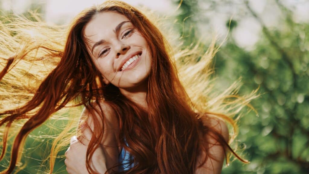 happy red head woman in sunlight. 